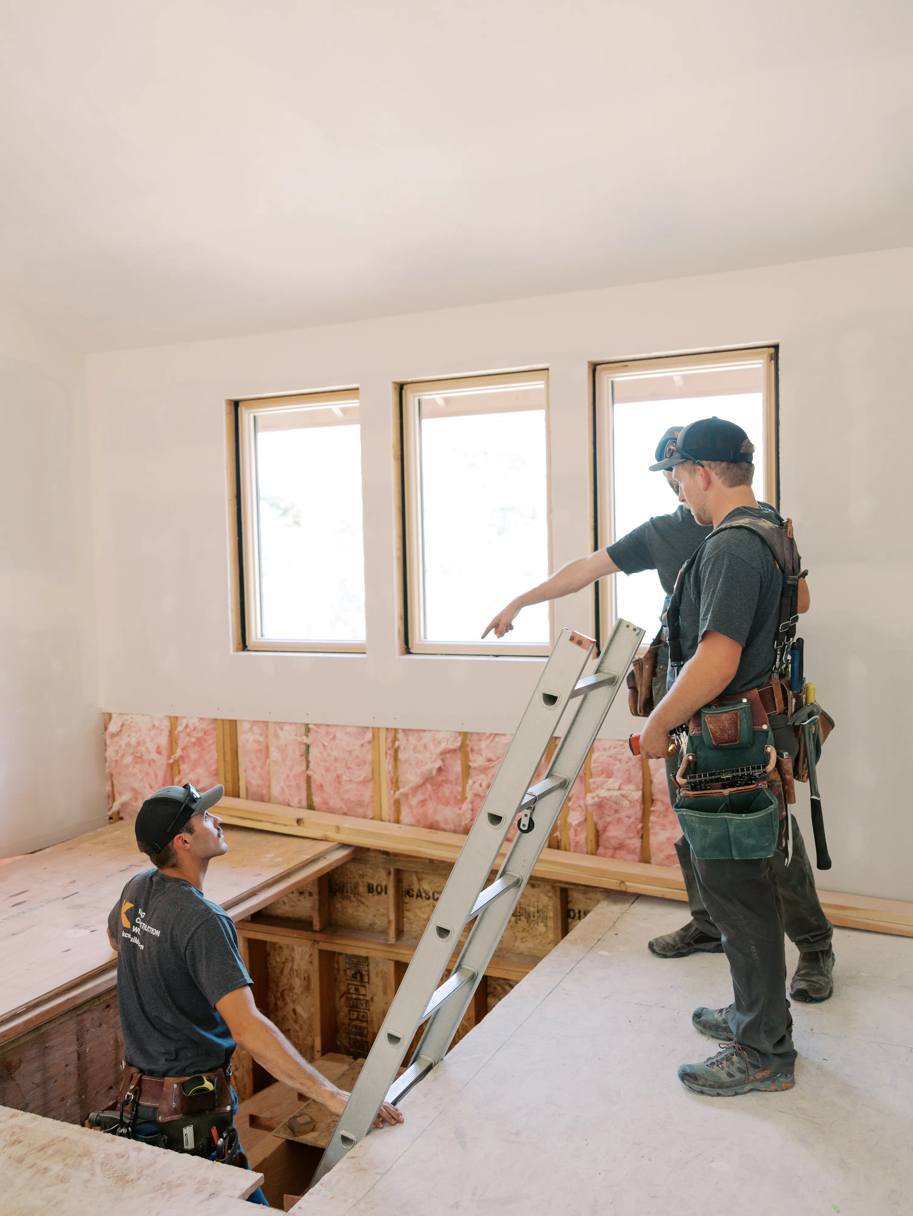 Two KCW crew members reviewing framing where new space ties in
