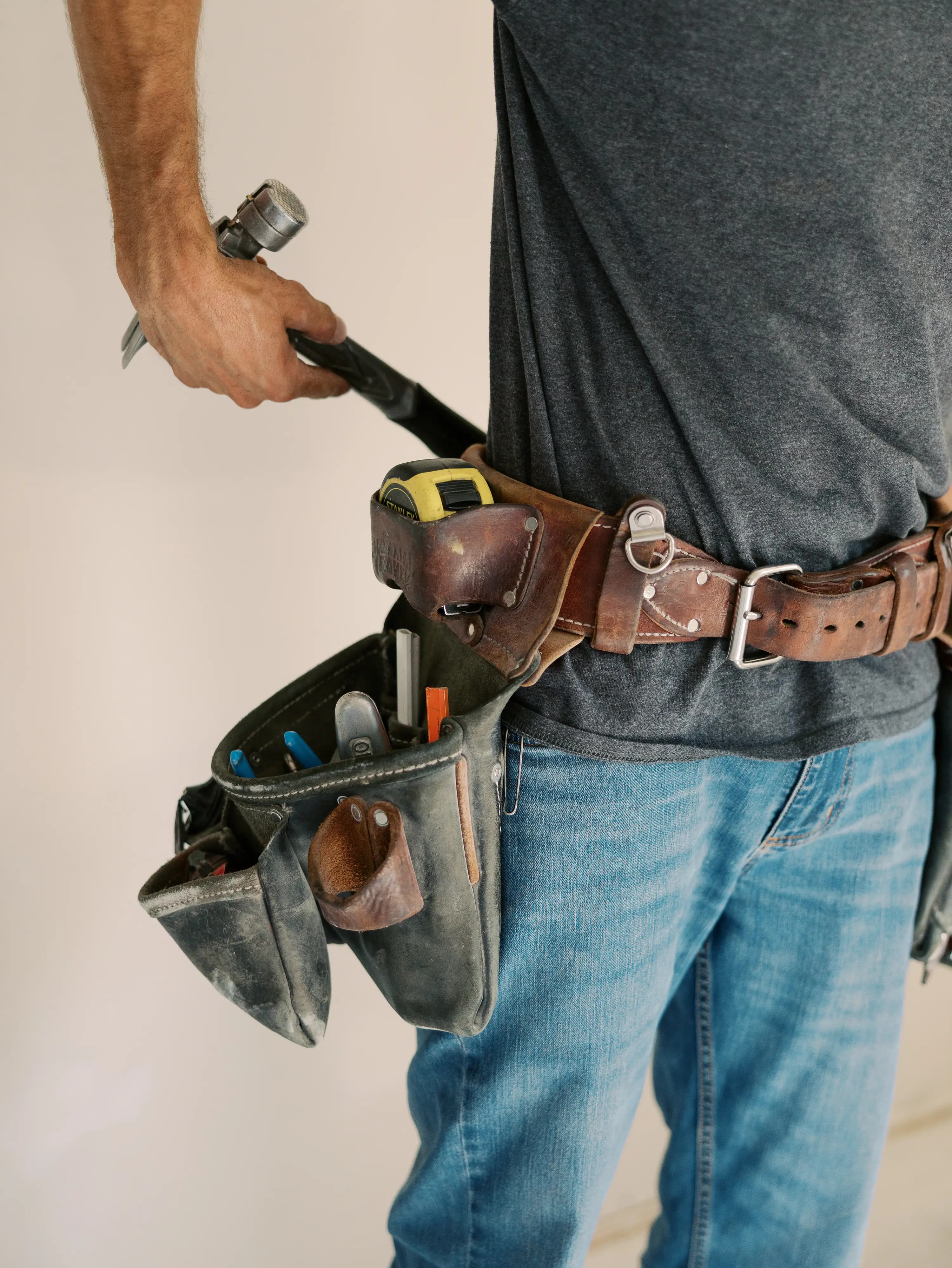 A builder’s tool belt on a KCW job site
